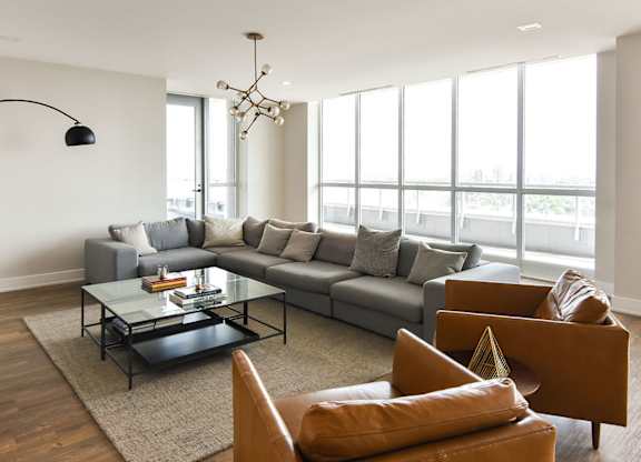 Modern living room with sectional and coffee table at 929 Richmond Apartments, Ottawa, ON K2B 6R1