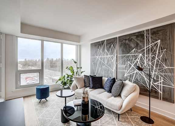 Modern living room with geometric wall art at Baseline Apartments, Ontario, K2H 0C9