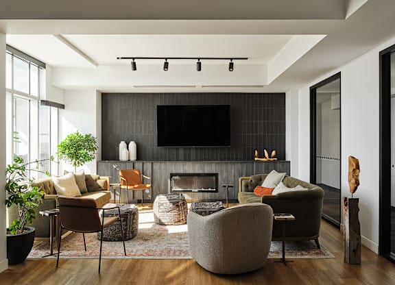 A modern living room with a fireplace and a flat screen TV.