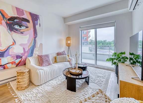 A living room with a large painting of a woman's face on the wall. at Château golf, Gatineau, J9H 0M9