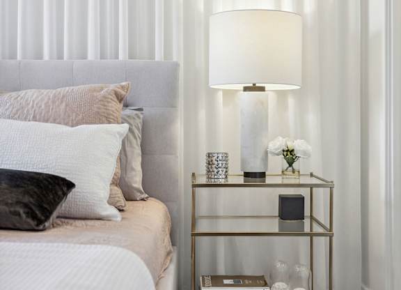 Bedroom nightstand with marble table lamp at Horizon Apartments, Gatineau