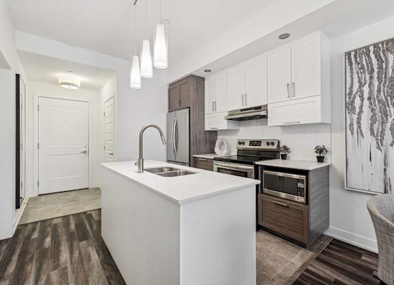 Modern kitchen with white island and pendant lighting at Horizon Apartments, Gatineau, J9A 0G9