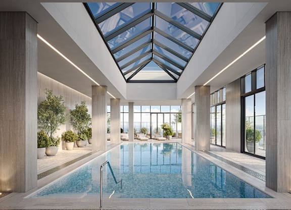 A large indoor swimming pool with a skylight above it at Petries Landing I Apartments , Ottawa, ON