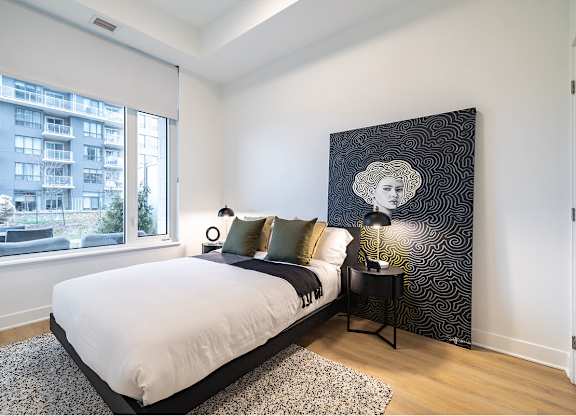 Modern bedroom with artistic wall decor at Petries Landing II Apartments, Ontario