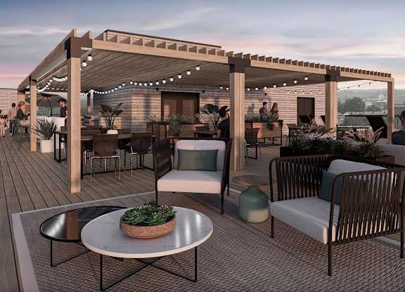 Rooftop terrace with outdoor seating and string lights at Petries Landing II Apartments, Ontario, K4A 0S8