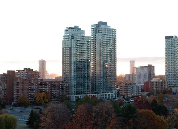 A cityscape with trees in autumnal colors in the foreground at The Dale Apartments , Ottawa, ON, K1Y 4Y5