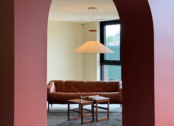 A living room with a brown couch and a table.
