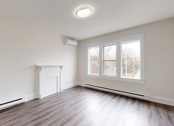 A room with a fireplace and a window.