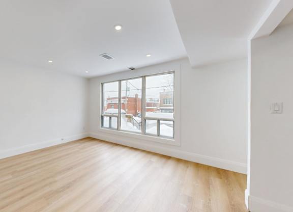 A room with a window overlooking a cityscape.