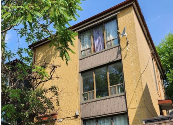 A brown building with a white door and windows.