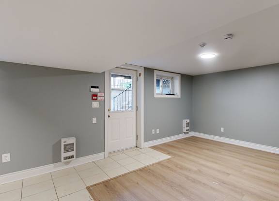 A room with a white door and a window.