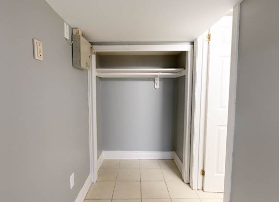 A room with a white door and a white wall.