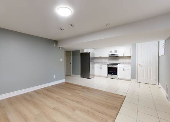 A kitchen area with a refrigerator, oven, and microwave.