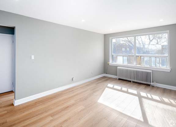 A room with wooden floors and a white door.