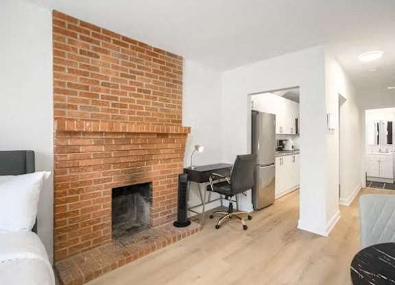 A room with a fireplace and a chair.