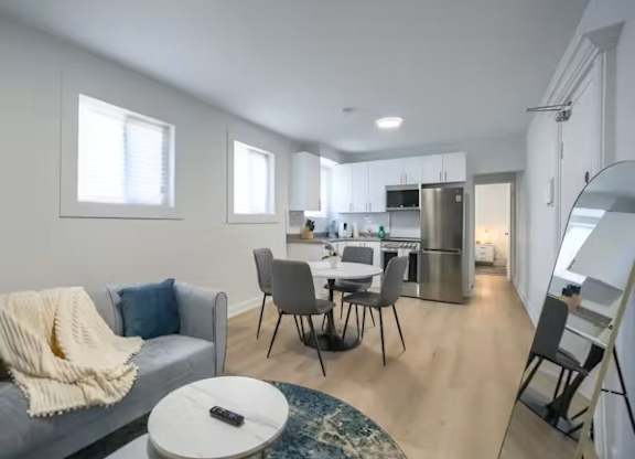 A modern living room with a grey couch and a coffee table.