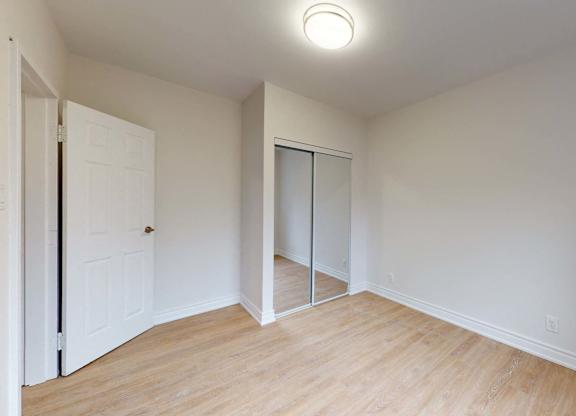 A room with a white door and a white wall.