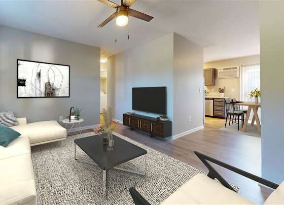 A living room with a white couch and a television at Ridgeview Apartments, Indiana