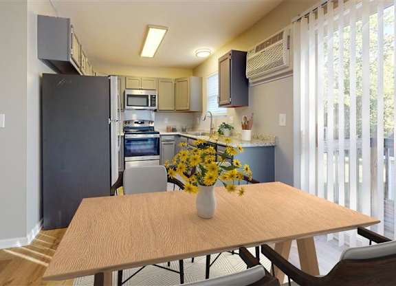 A kitchen with a table and chairs in front of it at Ridgeview Apartments, Fortville 46060