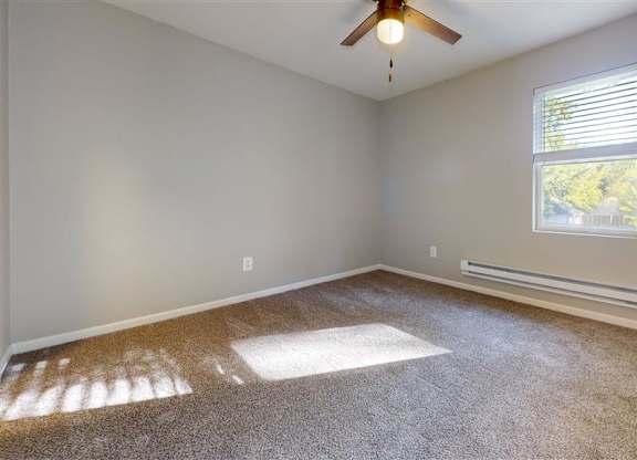 A room with a ceiling fan and a window with blinds at Ridgeview Apartments, Fortville, Indiana