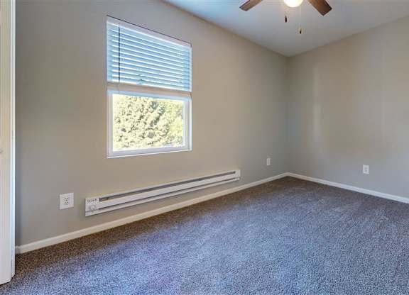 A room with a window and a ceiling fan at Ridgeview Apartments, Fortville 46060