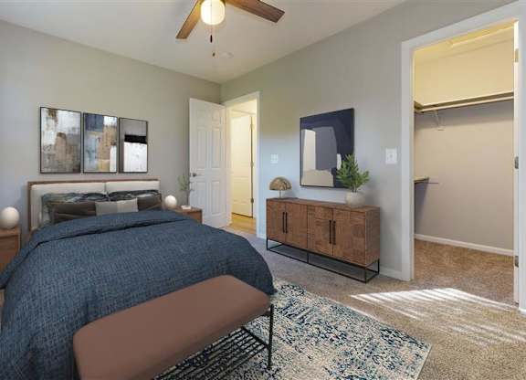 A bedroom with a bed, a ceiling fan, and a rug at Ridgeview Apartments, Indiana