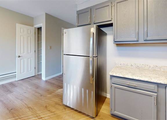 A kitchen with a refrigerator and cabinets at Ridgeview Apartments, Fortville