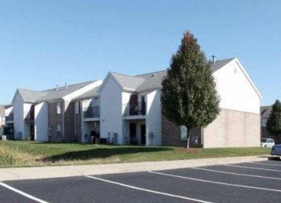A large white building with a parking lot in front. at Ridgeview Apartments, Fortville