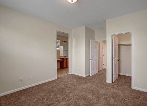 A room with carpeted floor and white walls.