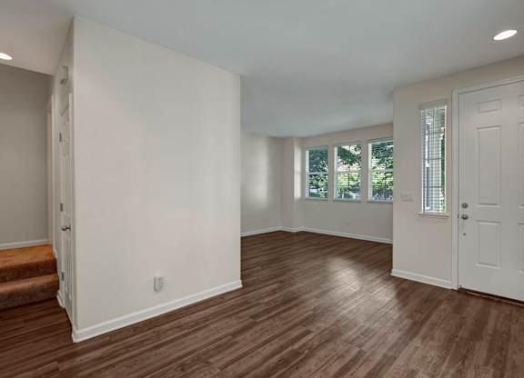 A room with wooden floors and white walls.