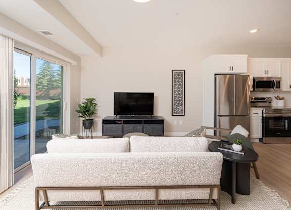 A modern living room with a white couch and a television.