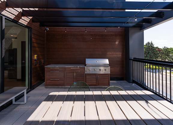 A patio with a table and chairs under a roof.