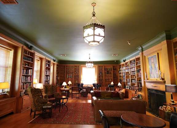 A room with a green ceiling and a chandelier hanging from it.