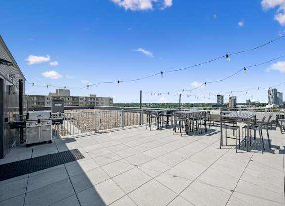 Rooftop terrace with seating and city views at Ophelia on Queen Apartments, Kitchener, N2G 0E7