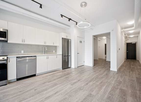 Modern kitchen and open floor plan at Ophelia on Queen Apartments, Kitchener