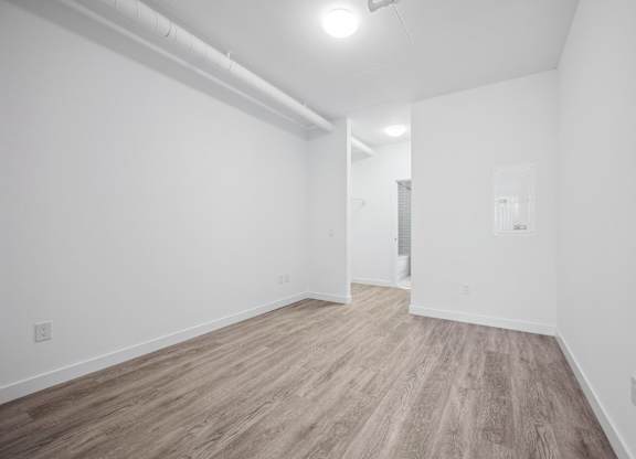 Empty bedroom with wood style flooring at Ophelia on Queen Apartments, Ontario, N2G 0E7