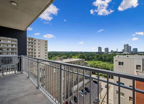 Balcony with city skyline and green space views at Ophelia on Queen Apartments, Kitchener, N2G 0E7