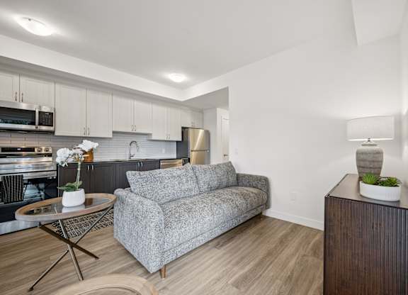 Living room with couch at The Maverick Apartments, Kitchener, ON N2H 0E3
