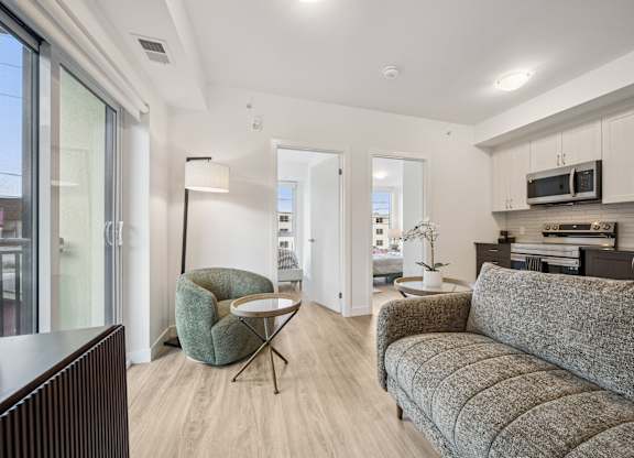 Open concept living area with modern kitchen at The Maverick Apartments, Ontario