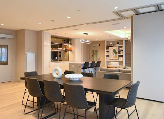 A modern dining room with a table set for four at Roxy Apartments, Hamilton, ON
