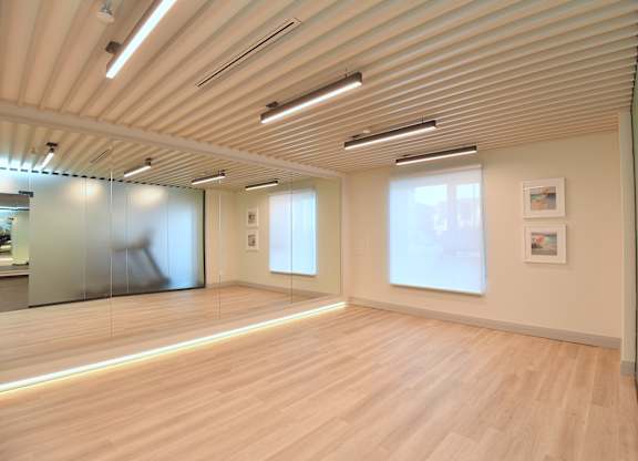A room with wooden floors and a glass wall at Roxy Apartments, Hamilton, ON, L8H 0B7