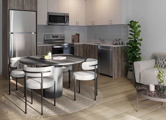 A modern kitchen with a round table and chairs at Roxy Apartments, Ontario, L8H 0B7