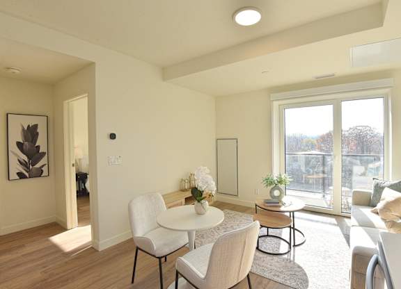 A modern living room with a white table and chairs at Roxy Apartments, Ontario