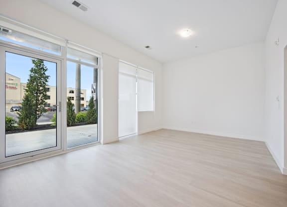 Spacious empty room with patio door access at The Maverick Apartments, Ontario