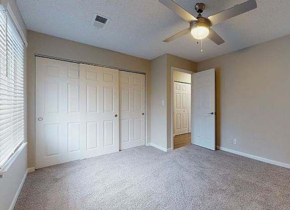 A room with a ceiling fan and carpeted floor. at Spalding Vue, Peachtree Corners, GA, 30092