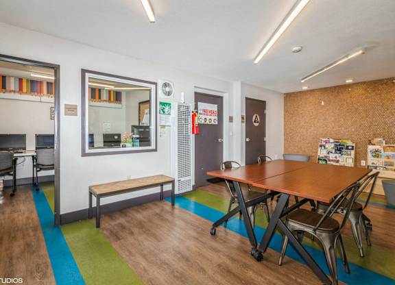 A room with a table and chairs in it.