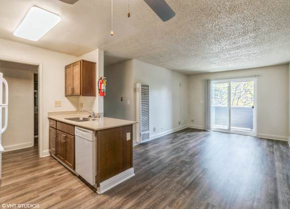 A kitchen with wood floors and a white countertop at Oak Center Apartments, Oakland, CA, 94607