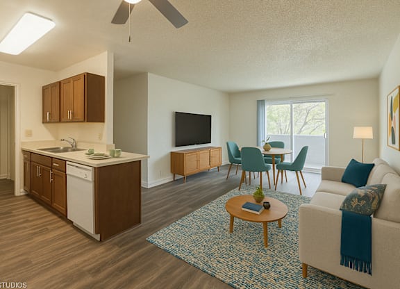 A living room with a couch, chairs, and a television at Oak Center Apartments, Oakland