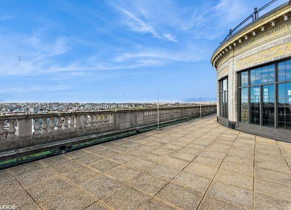 A balcony with a railing and a building with a glass facade at Mohican Apartments, New London, 06320