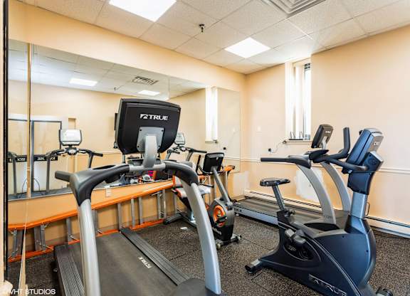 A gym with treadmills and elliptical machines. at Mohican Apartments, New London, Connecticut